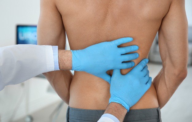 Urologist in gloves examining young patient in clinic | Getting To Know The P Spot (Male G-Spot)