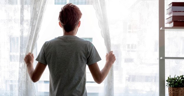 man-opening-curtains-when-waking-up