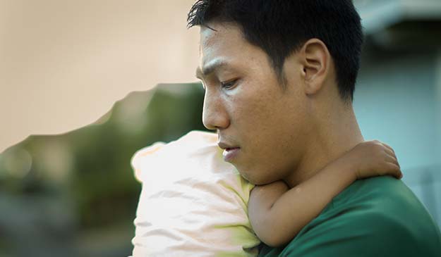 Distressed father holding his baby | Postpartum Depression: An Overview | Can Dads Get Postpartum Depression? | Can Dads Get Postpartum Depression?