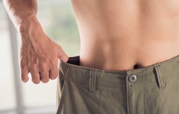 Close-up of a man in wide trousers losing weight | Benefits of BHRT for Men | What is BHRT? Men's Guide to Hormone Replacement Therapy
