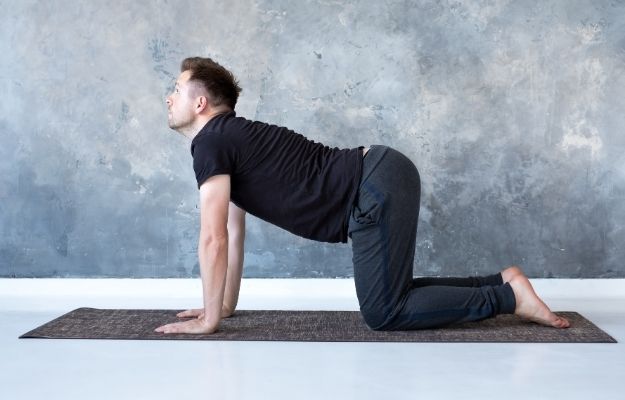 a man is doing Cat-Cow yoga Pose | Cat-Cow Pose | 5 Yoga Sex Positions To Help In The Bedroom