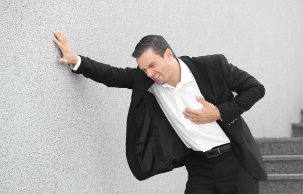 man in suit is having a heart attack | Heart Diseases | 5 Top Male Health Concerns and What You Can Do 