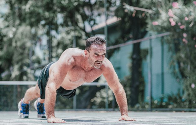 Fitness middle aged man doing push-ups. Male athlete exercising outdoors. Sports and active lifestyle. Body goals. Horizontal shot | 5 Simple Exercises for Building Muscles