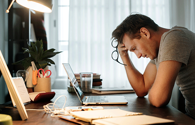 Man-stressed-while-working-on-laptop- | What Are the Psychological Factors Involved in E.D.?