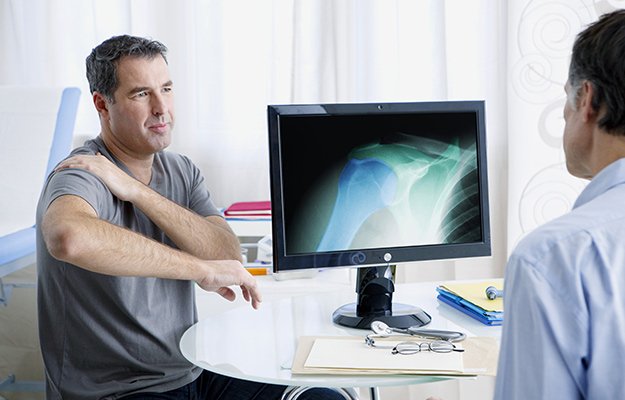 A middle aged man having osteoporosis check up with doctor | What Causes Osteoporosis in Men and Who Is Vulnerable to This Bone Disease?