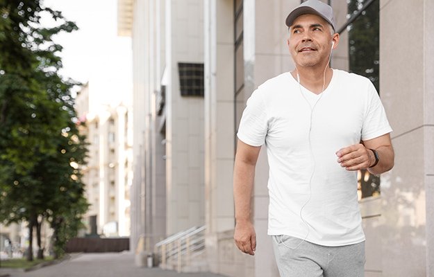 A middle aged man walking in the street | 6 Ways To Battle Sarcopenia (Muscle Loss) And Become Physically Fit
