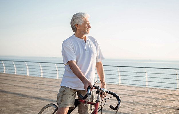 A senior man riding bicycle along the beach | 9 Tell-Tale Signs of Nutrient Deficiency in Older Adults