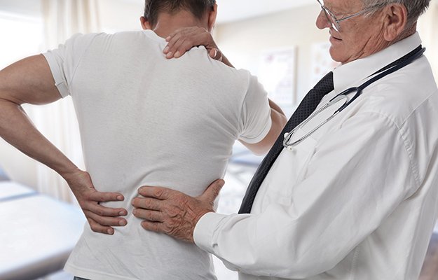 Doctor checking up a patient having back pain | What Causes Osteoporosis in Men and Who Is Vulnerable to This Bone Disease?