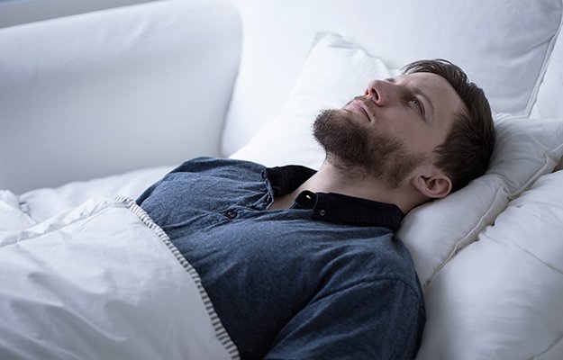 A man having sleep disorder | What Causes Sleep Apnea and How to Prevent It