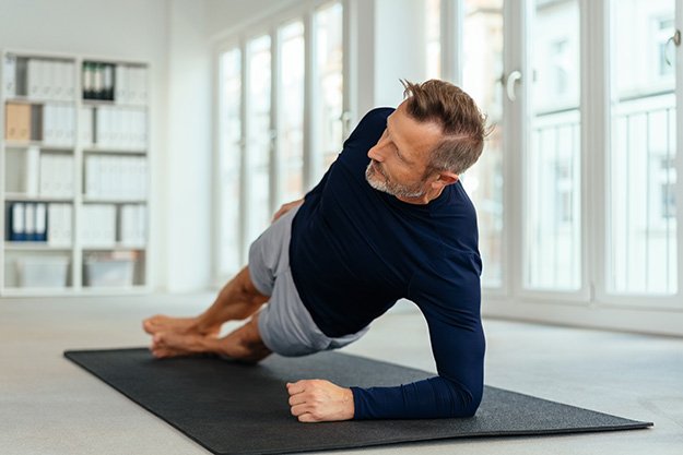 Middle-aged-man-working-out-doing-side-stretches-Take-Back-Control-ss-body | Are You At Risk Of Andropause? Tell-Tale Signs Of Male Menopause