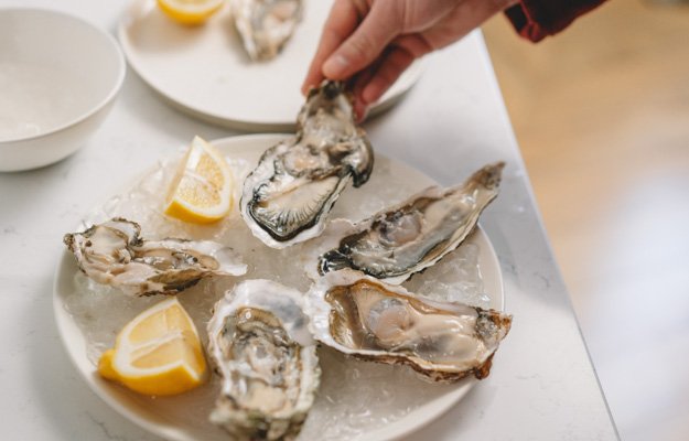 A dish full of raw oysters | Eat These 8 Foods To Boost Testosterone Naturally