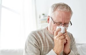 A senior man sneezing_ss