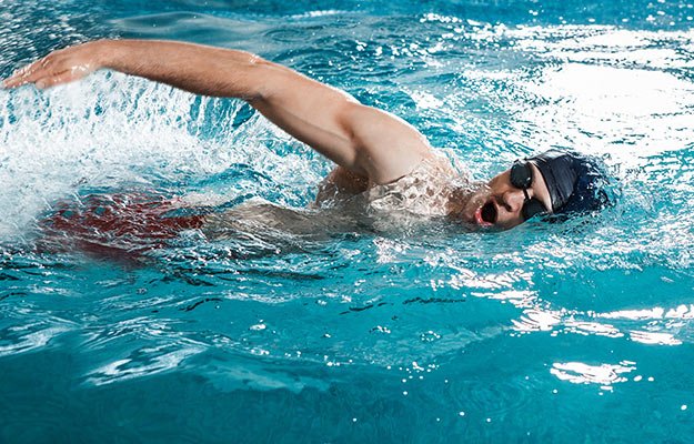 Man swimming in the blue pool | Low Impact Exercises That Keep You Fit