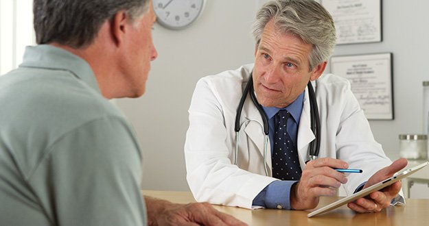 Mature-doctor-talking-to-patient-and-tablet-in-office-How-Is-Andropause-Diagnosed-ss-body | Are You At Risk Of Andropause? Tell-Tale Signs Of Male Menopause