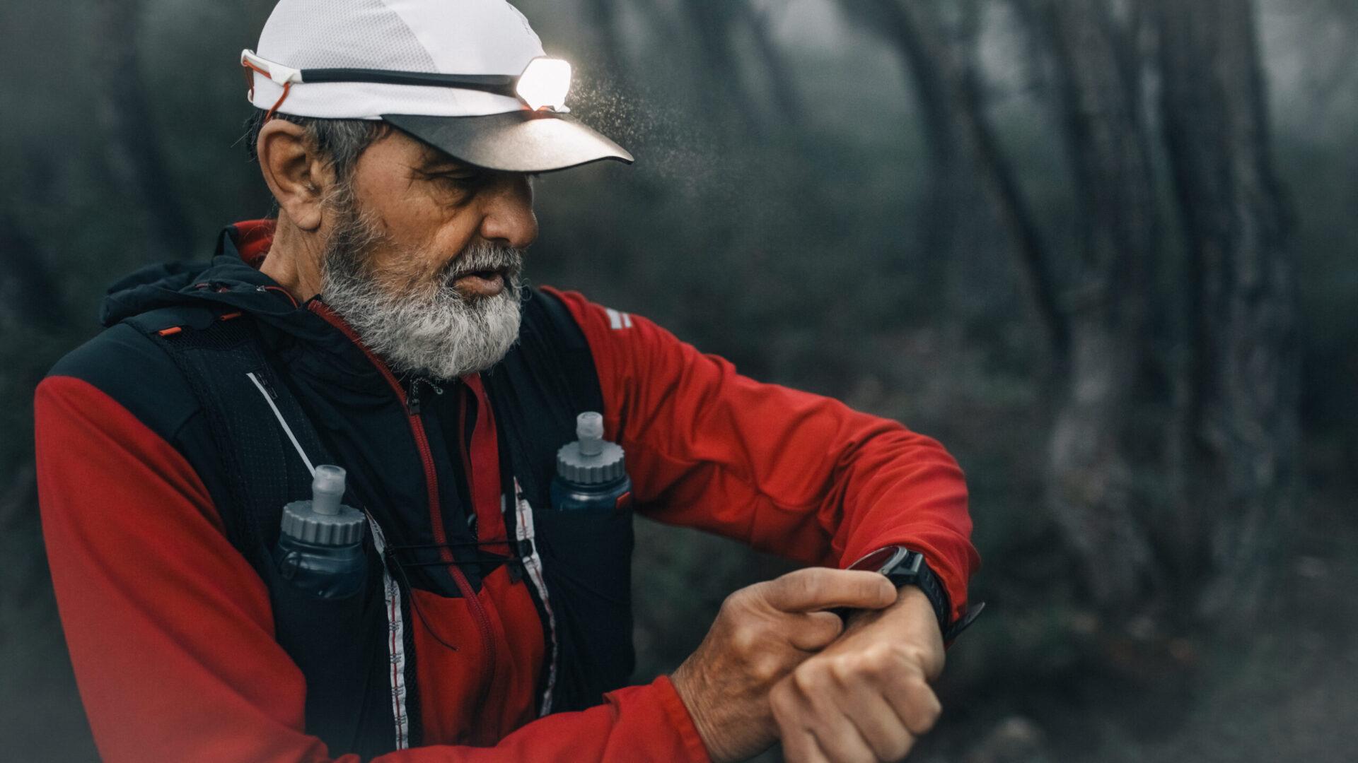 Man trail running outdoors at dusk