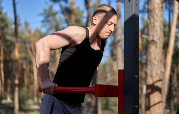 a guy doing body-building | Be Active and Keep Moving | Daily Strategies To Perform On Top Of Your Game