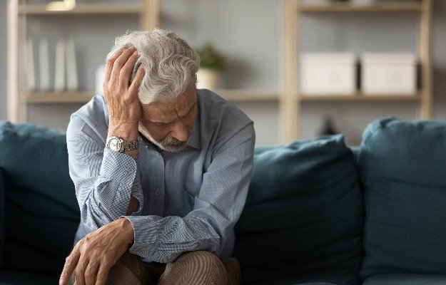 anxious middle aged man | 5 Signs Of Hormonal Belly & How To Get Rid of It