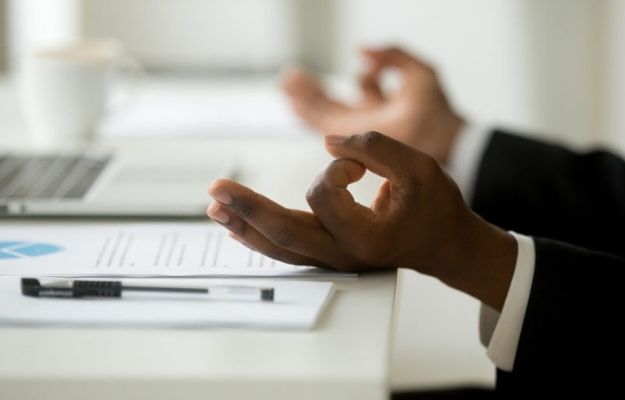 businessman relaxing meditating in office | How Often Should I Meditate? | When Is The Best Time To Meditate For Optimized Health?