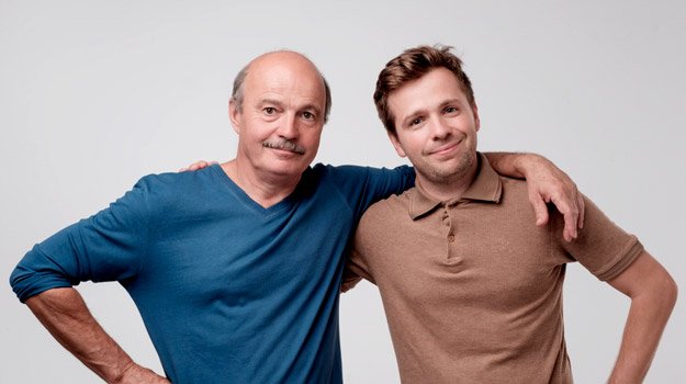 close-bald-father-and-young-adult-son-holding-each-other-by-shoulders-ss | Male Pattern Baldness Symptoms & FAQ