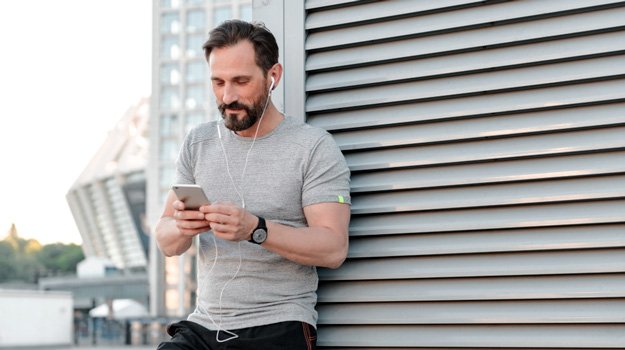 Middle aged man listening to music while working out