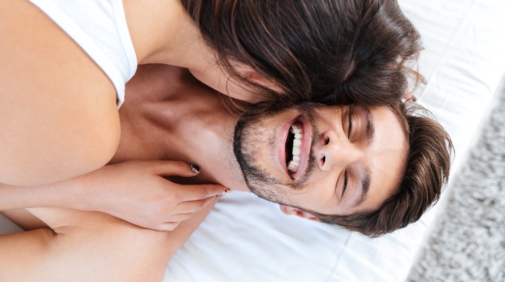 handsome man looking happy in bed | feature | Getting To Know The P Spot (Male G-Spot)