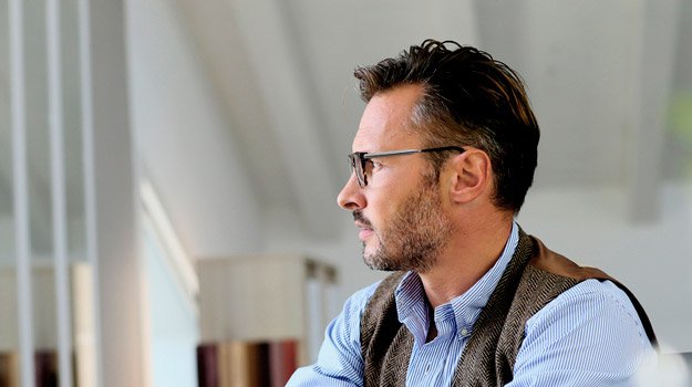 mature-man-with-glasses-in-thought-while-working-from-home