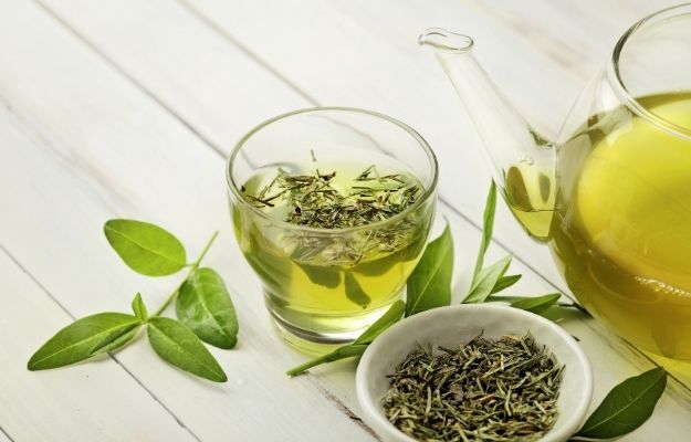 cup of green tea with tea leaf inside | 5 Drinks for Hangover Cure