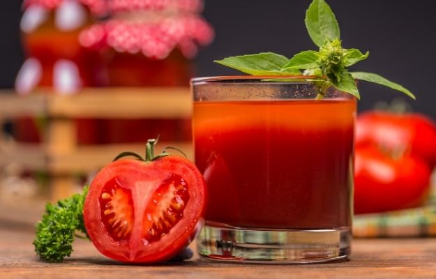 cup of tomato juice with half of tomato aside | Tomato Juice | 5 Drinks for Hangover Cure