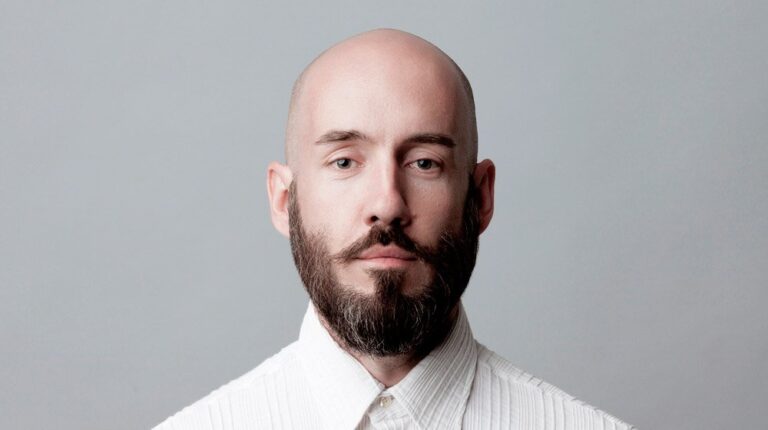 confident-bald-middle-aged-man-studio-shot-on-grey-background