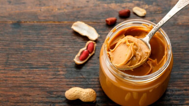 peanut-butter-with-spoon-on-wooden-table