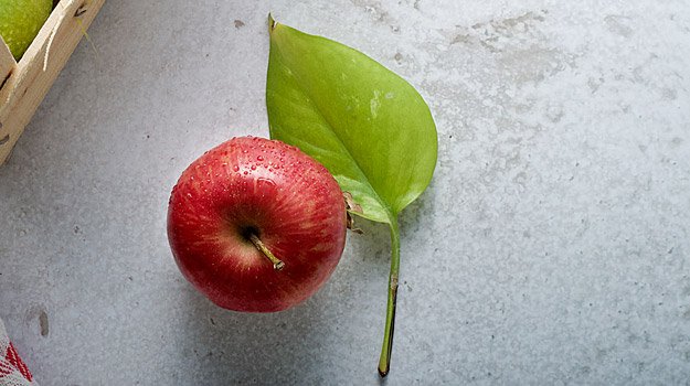 red-apple-with-leaf-on-concrete | 5 Foods to Increase Stamina