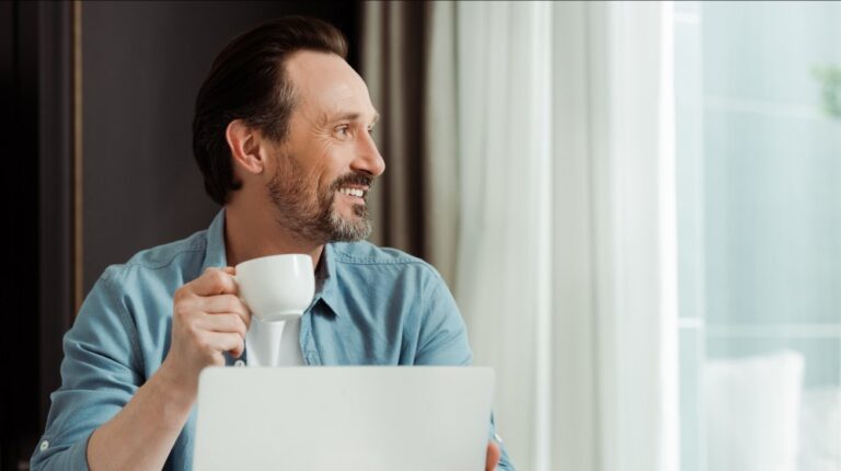 Selective-focus-of-smiling-man-drinking-coffee | Feature | The Game-Changing Benefits of TRT