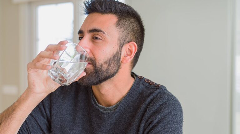 A caucasian man drinking water | Feature | 12 Interesting Reasons You Need To Drink More Water