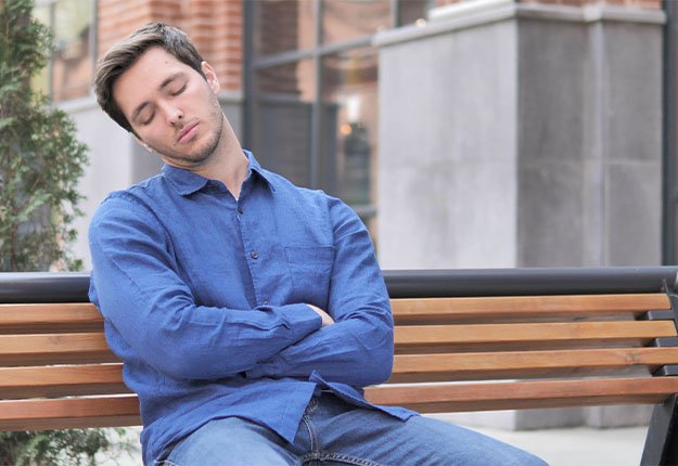Young Man Sleeping while Sitting Outdoor on Bench-ss-5. Fatigue | 12 Signs That You Need a Testosterone Test