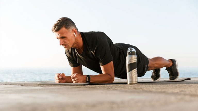 Confident sportsman doing plank_MK-677 Benefits & Side Effects You Need to Know | feature | MK-677 Benefits & Side Effects You Need to Know