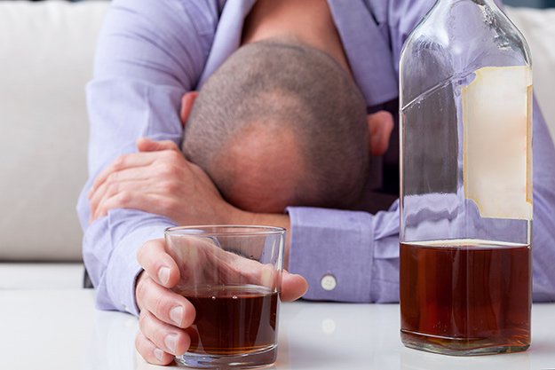 Drunk-man-in-shirt-sleeping-on-the-table-Avoid-Alcohol | What Are Meat Sweats? Causes, Symptoms & Prevention