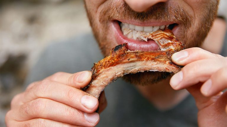 Man-Eating-Barbecue-Ribs-What-Are-Meat-Sweats-ss-feature | What Are Meat Sweats? Causes, Symptoms & Prevention